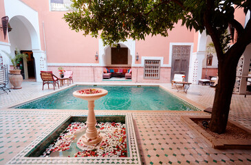 Oriental hospitality. Traveling by Morocco. Relaxing in festive moroccan traditional riad interior...