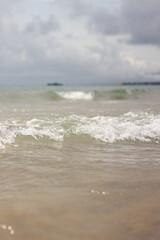 Sea view with small waves in cloudy weather. Balearic Sea, Salou, Spain. View of the waves on the sea from a lower angle. Landscape with sea and clouds