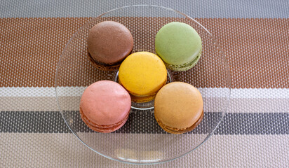 Close up of different pastel colored macaron cakes filled with cream. Culinary and cooking concept. Tasty colorful macarons