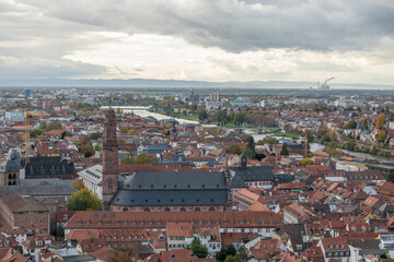 Obraz premium View from Heidelberg castle towards the town Heidelberg during autumn. Jesuiten church Heiliger Geist und ST. Ignatius. Wonderful landscape with hills, forests and city centre. 31 october 2023, Heidel