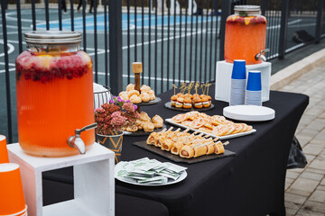 A beautifully arranged table showcases a variety of delicious food and drinks, elegantly set for everyone to enjoy and share together in a harmonious and joyful atmosphere of togetherness