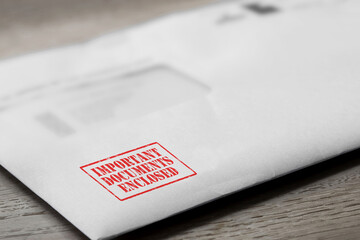 Important documents enclosed letter stamped in red on an envelope. Official business paperwork mail...