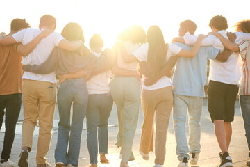 Group of students walking together in line with arms around each other's shoulders