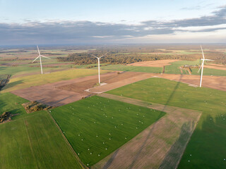 Wind Turbine Wind Park. Aerial Drone View. Aerial Drone Point of View, with more wind turbines in the distance. Sustainable synergy of onshore and farming. Beautiful Landscape. Golden Hour