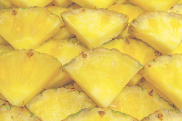 Pineapple juicy yellow slices as a background.