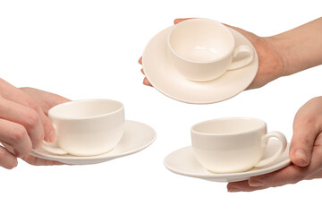Female hand holding coffee cup and saucer isolated on white background.