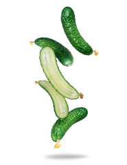 Ripe whole and cut cucumbers in the air close up isolated on a white background