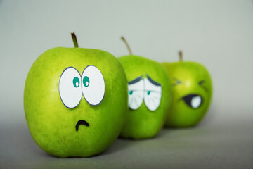 social group emotion of surprise, shock and confusion face on an apple - abstract image of human...