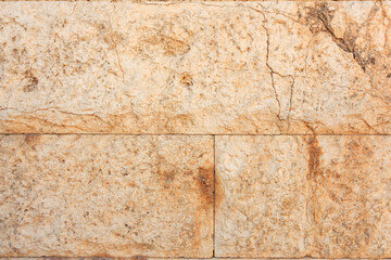 A wall with a rough, weathered texture