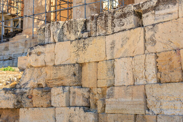 A wall made of stone blocks with a few holes in it, Acropolis in Athens