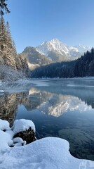 Fototapeta premium Tranquil winter morning by the serene lake reflecting majestic mountains under a clear sky