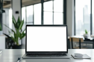Fototapeta premium Empty white laptop on a desk in a modern office, customizable for design needs