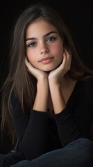 Fototapeta premium A serene moment captured of a young girl in a cozy black sweater with a thoughtful expression