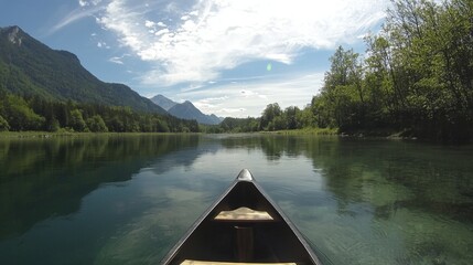 A serene canoe journey through crystal-clear waters surrounded by majestic mountains
