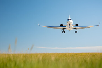 Private Jet Flying Above a Grass Field | Luxury Air Travel with Scenic Views of Open Countryside