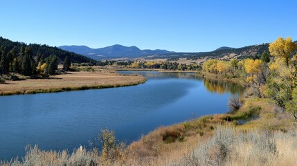 Tranquil river winding through vibrant autumn landscape in the mountains