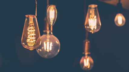 Retro light bulbs hanging on a dark background. Electricity, Vintage