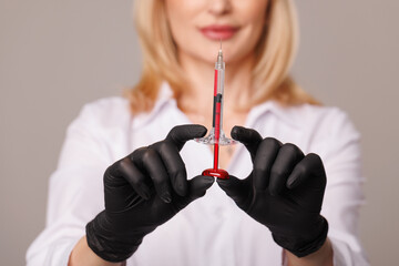 woman cosmetologist holds cosmetology syringes close-up, modern cosmetology and aesthetic medicine