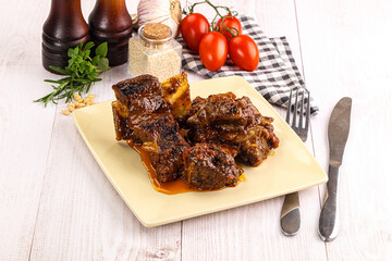 Prepared tasty beef ribs with sauce