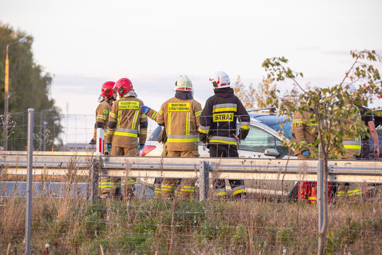 Funkcjonariusz straży pożarnej podczas akcji ratunkowej przy wypadku samochodowym. Straż ogniowa. Państwowa Straż Pożarna
