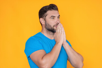 Christian Religion. Man with Praying hands praying. Isolated portrait of male pray.