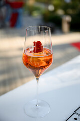 Glass of pink sparkling wine at an event