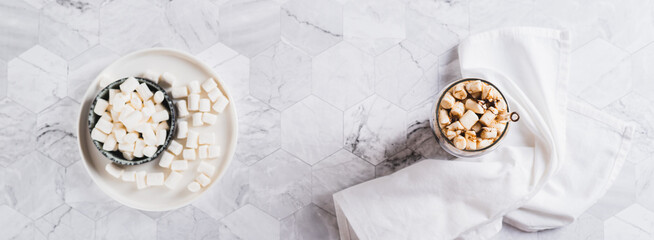 Refreshing fluffy coke with marshmallow in a glass on the table top view web banner