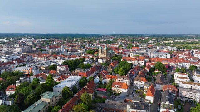 Aerial view of Osnabruck city center in Germany. The camera is panning over the city center, showing the old town and St. Peter's church