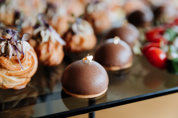 Gourmet chocolate desserts and savory prosciutto appetizers displayed for event or catering service