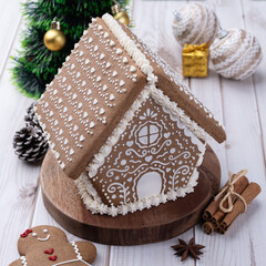 Fototapeta premium Traditional christmas gingerbread house over a wooden table