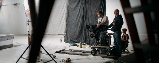 Carts, rails for filmmaking. Director of photography and engineer of movie camera trolley on set.