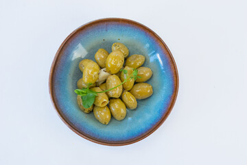 Green olives in blue dish top view