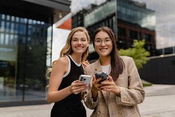 young pretty women walking outside in street doing business