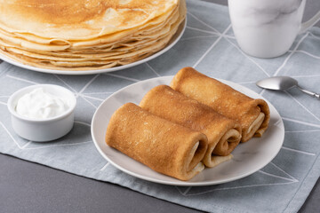 Savory pancake rolls stuffed with ground meat, isolated on grey background