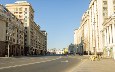 Fototapeta premium Panorama of Moscow street. Large building of the State Duma, police nearby. Several cars on the road. One of the central streets of the Russian capital.