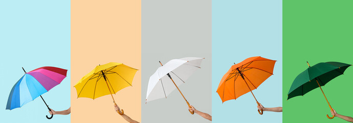 Set of hands holding umbrellas on color background