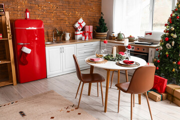 Kitchen interior with Christmas tree, new year decorations and served table