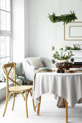 Festive table setting for Christmas dinner in modern living room