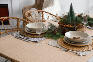 Christmas table setting with fir branches and pine cones