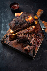 Traditional barbecue burnt chuck beef ribs marinated with spicy rub and served as close-up on an...