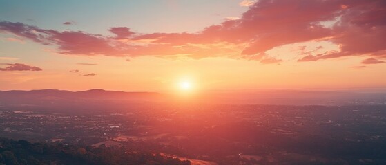 Fototapeta premium A Golden Sunset Over a Sprawling Cityscape with Rolling Hills in the Distance
