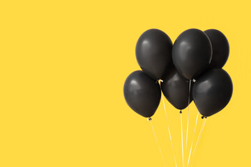 Black air balloons on yellow background. Black friday concept