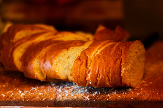 Fresh sliced bread on a rustic wooden cutting board