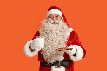 Santa Claus with glass of milk and tasty cookies on orange background
