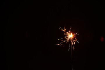 Fototapeta premium Christmas sparkler on black background
