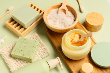 Set of cosmetic products on green background