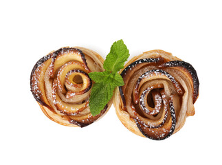 Freshly baked apple roses with mint isolated on white, top view. Puff pastry
