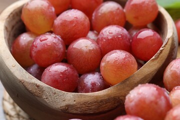 Delicious fresh ripe grapes in bowl, closeup