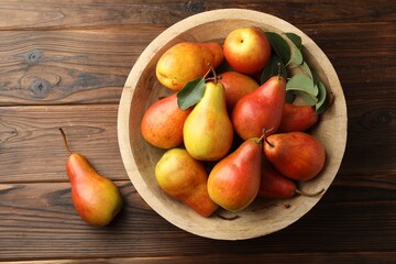 Ripe juicy pears on wooden table, top view