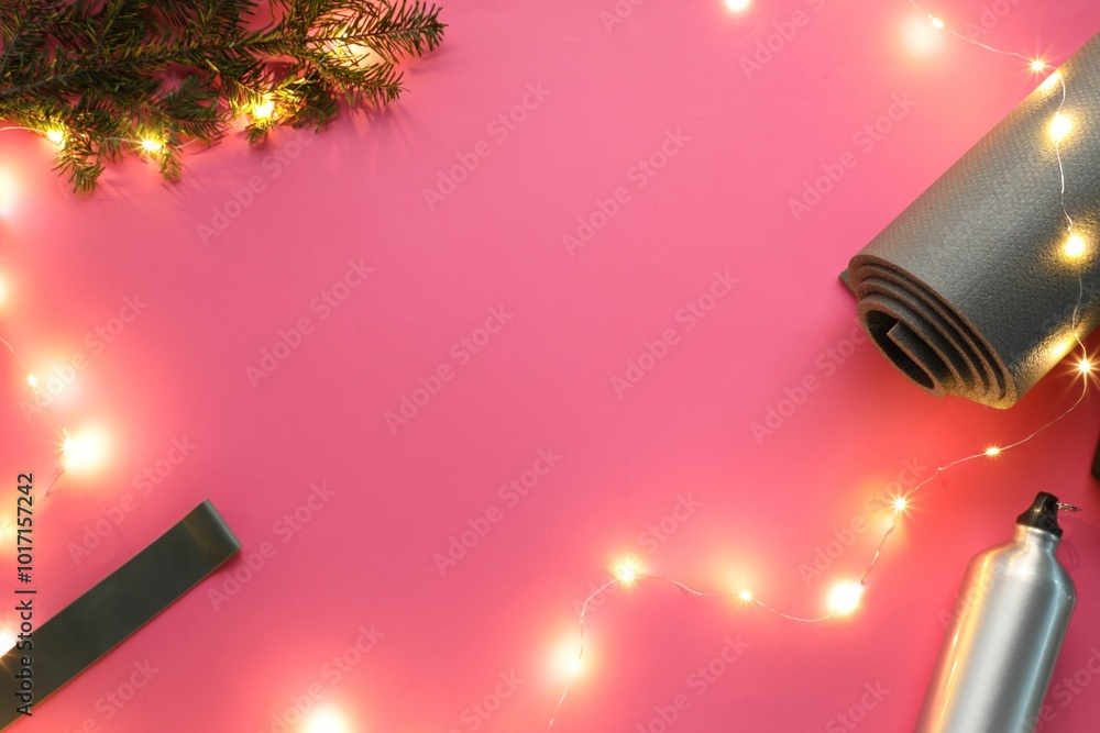 Canvas Prints Yoga mat, band, bottle and Christmas decor on pink background, flat lay. Space for text